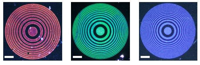 Lenses made of gold (left), silver (center) and aluminum (right) nanoparticles. Each layer of the lens focuses light of a different color, each to the same point. Scale: 35 μm