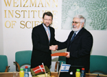 Denmark’s Minister of Science, Tech-nology and Innovation Helge Sander (l) shakes hands with Prof. Haim Garty