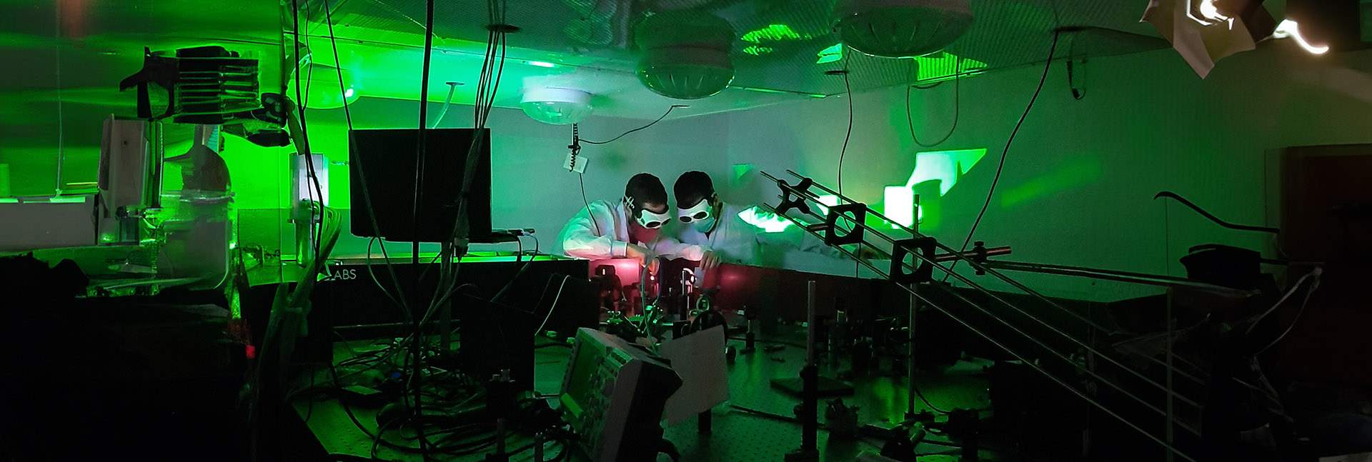 Dr. Omer Kneller (left) and Chen Mor direct a laser beam before it enters the experimental setup. The experiment required a powerful laser beam that could produce exceptionally short, attosecond light pulses. Photo: Noa Yaffe